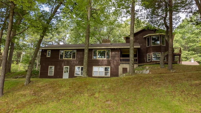 5774 N Wayne Ave, Pentwater, MI 49449 - rear view of property featuring a chimney and a yard