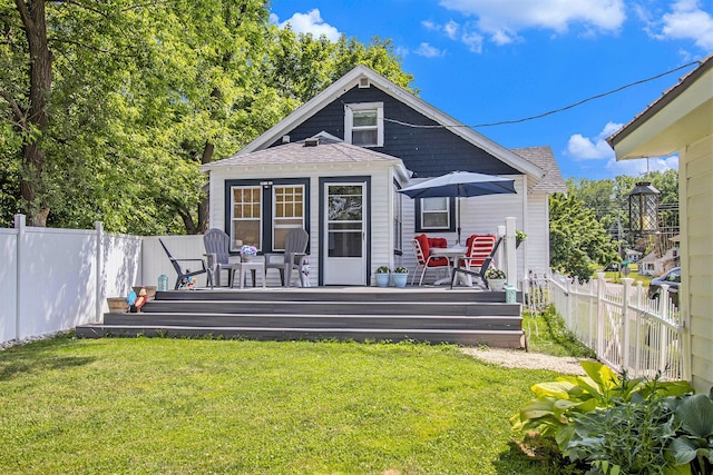 378 Goguac St W, Battle Creek, MI 49015 - back of house featuring a fenced backyard, a wooden deck, and a shingled roof