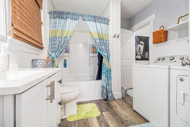 378 Goguac St W, Battle Creek, MI 49015 - bathroom with separate washer and dryer, wood finished floors, vanity, shower / tub combo with curtain, and a textured ceiling