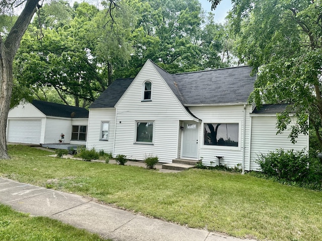 1478 Allen Ave, Muskegon, MI 49442 - view of front of home with a shingled roof, a front yard, an outdoor structure, and a detached garage