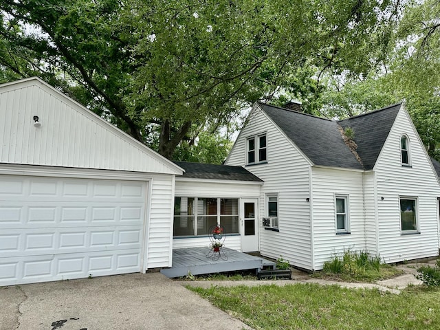 1478 Allen Ave, Muskegon, MI 49442 - view of front of house with roof with shingles, a chimney, cooling unit, and an outdoor structure