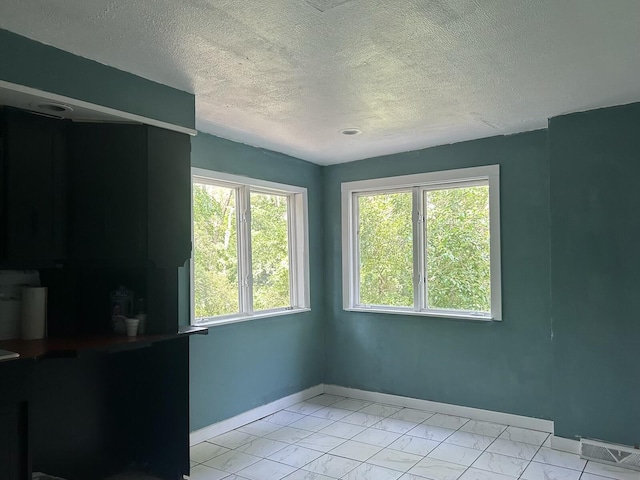 1478 Allen Ave, Muskegon, MI 49442 - empty room featuring light marble finish flooring and a textured ceiling