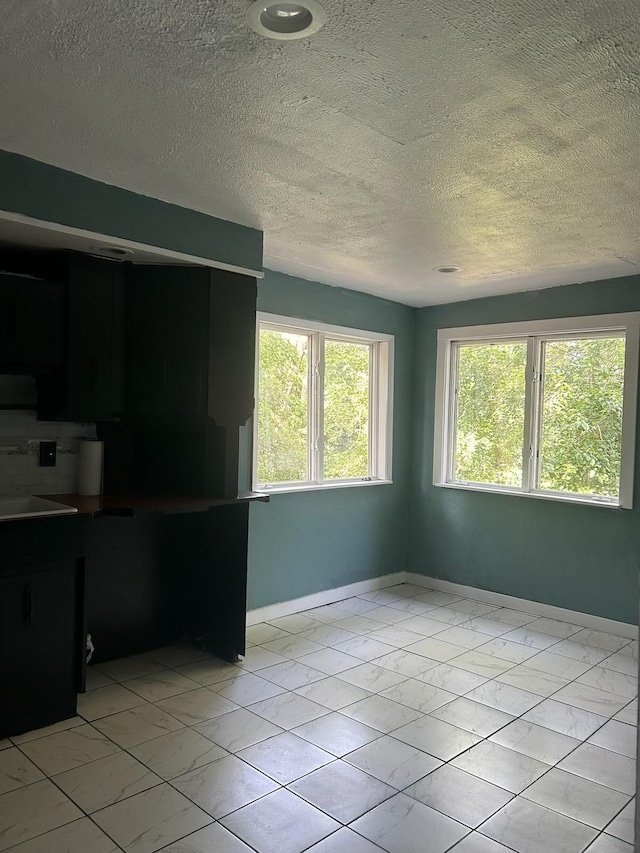1478 Allen Ave, Muskegon, MI 49442 - spare room featuring light marble finish floors and a textured ceiling