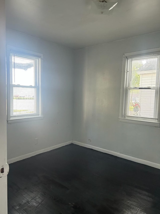 1478 Allen Ave, Muskegon, MI 49442 - spare room featuring baseboards and dark wood-style flooring