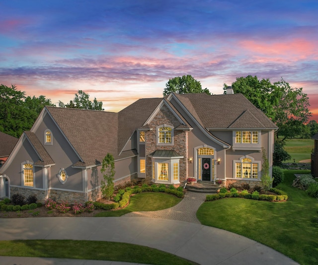 5011 Rockaway Ln, Clarkston, MI 48348 - view of front facade with stone siding, stucco siding, and a front lawn