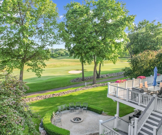 5011 Rockaway Ln, Clarkston, MI 48348 - view of grassy yard featuring a fire pit, a deck, golf course view, and a patio