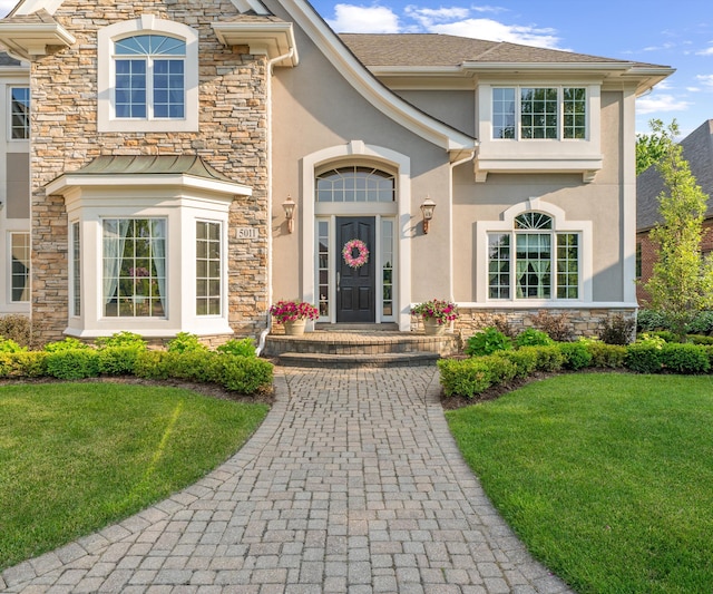 5011 Rockaway Ln, Clarkston, MI 48348 - view of front of house featuring stone siding, stucco siding, and a front yard