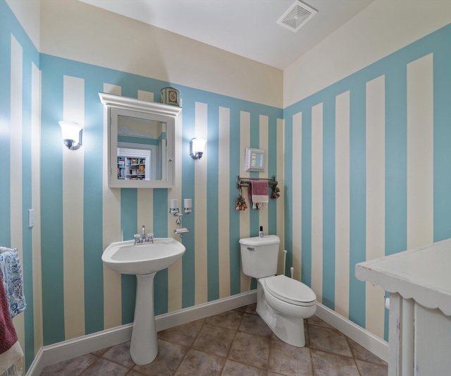 5011 Rockaway Ln, Clarkston, MI 48348 - half bathroom with toilet and tile patterned floors