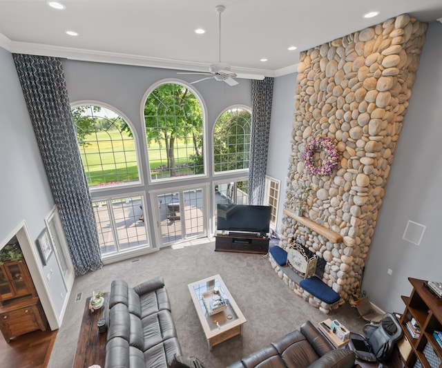 5011 Rockaway Ln, Clarkston, MI 48348 - living room with recessed lighting, ceiling fan, crown molding, a towering ceiling, and a fireplace