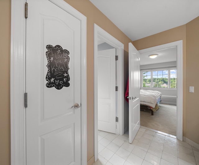 5011 Rockaway Ln, Clarkston, MI 48348 - hallway with light colored carpet and light tile patterned floors