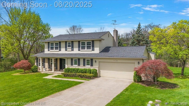 4160 Dawn Ln, West Bloomfield, MI 48323 - view of front of house featuring a garage, concrete driveway, a front lawn, and a porch