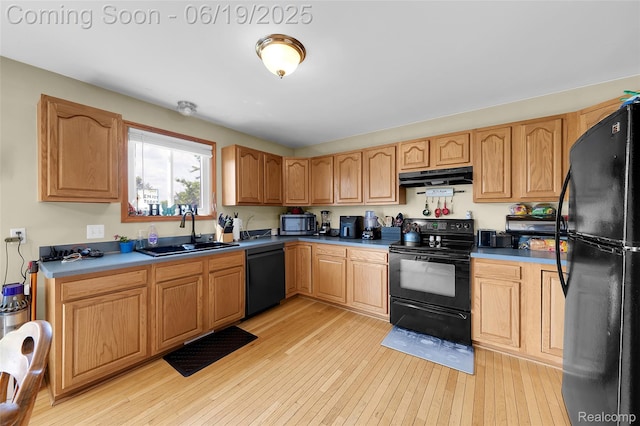 2102 Oakwood Rd, Ortonville, MI 48462 - kitchen with black appliances, under cabinet range hood, and light wood-style flooring