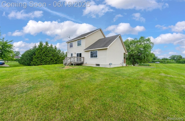 2102 Oakwood Rd, Ortonville, MI 48462 - rear view of house featuring a deck and a lawn