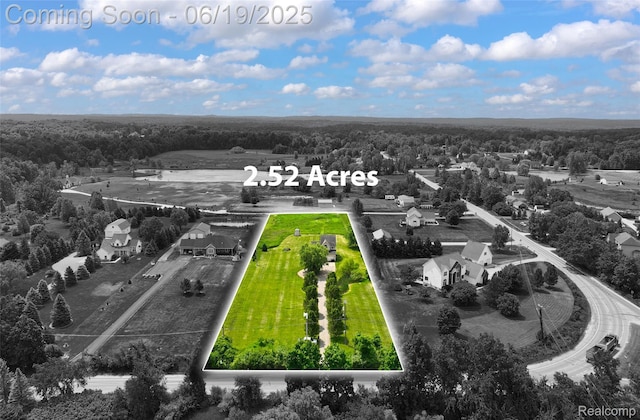 2102 Oakwood Rd, Ortonville, MI 48462 - aerial view of property and surrounding area featuring property boundaries highlighted and a heavily wooded area