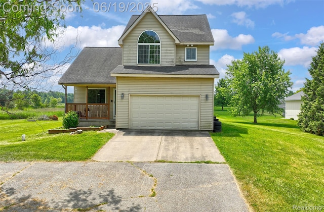 2102 Oakwood Rd, Ortonville, MI 48462 - view of front of house featuring concrete driveway, a garage, a front lawn, and roof with shingles