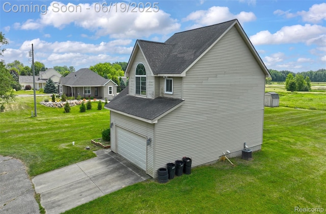 2102 Oakwood Rd, Ortonville, MI 48462 - view of home's exterior featuring roof with shingles, a garage, a lawn, and driveway