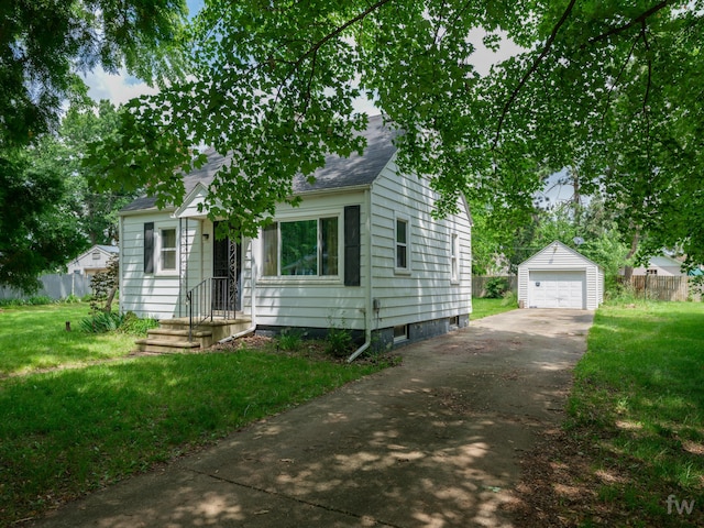 223 Ruth St, Portage, MI 49002 - view of front of property with concrete driveway, an outbuilding, a detached garage, and a shingled roof