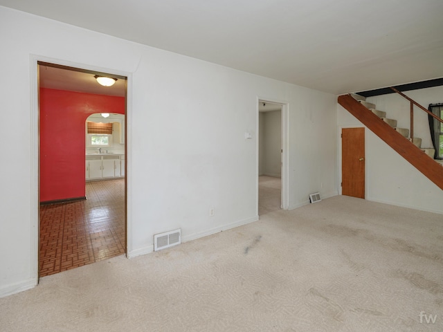 223 Ruth St, Portage, MI 49002 - empty room featuring stairs, carpet, and arched walkways