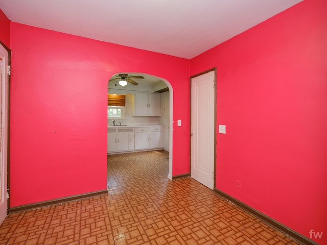 223 Ruth St, Portage, MI 49002 - empty room featuring brick patterned floors, ceiling fan, and arched walkways