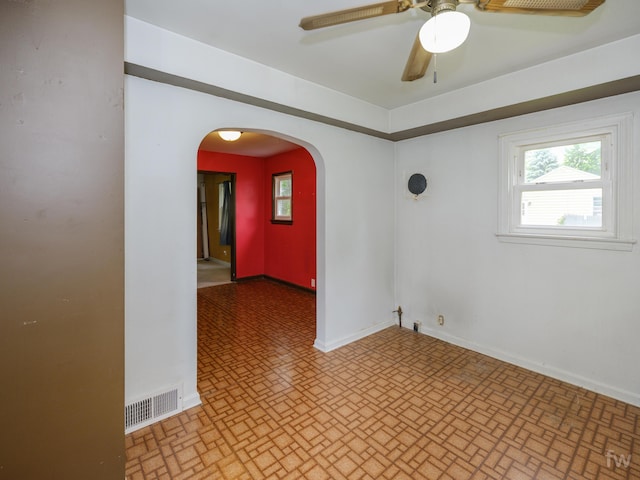 223 Ruth St, Portage, MI 49002 - empty room featuring brick patterned flooring, a ceiling fan, and arched walkways
