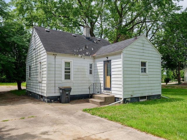 223 Ruth St, Portage, MI 49002 - view of front of home featuring a chimney, a front yard, and roof with shingles