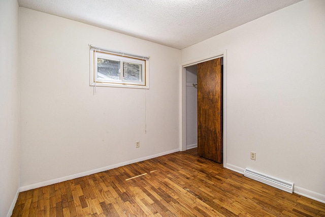 8814 S Sprinkle Rd, Portage, MI 49002 - unfurnished bedroom featuring wood finished floors and a textured ceiling