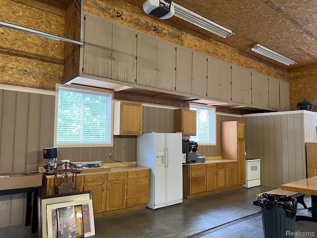 7369 Sheridan Rd, Flushing, MI 48433 - garage with white fridge with ice dispenser, a garage door opener, and refrigerator