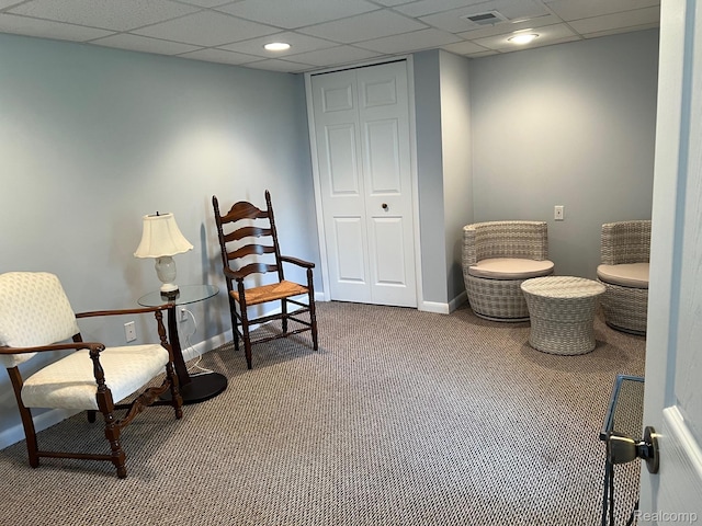 7369 Sheridan Rd, Flushing, MI 48433 - living area featuring dark carpet and a drop ceiling