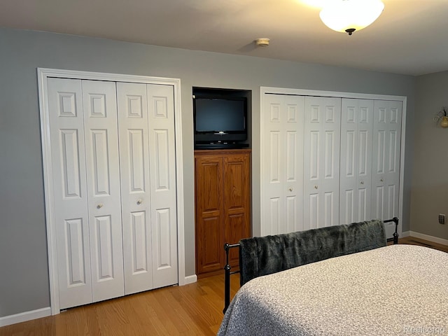 7369 Sheridan Rd, Flushing, MI 48433 - bedroom featuring multiple closets and light wood-type flooring
