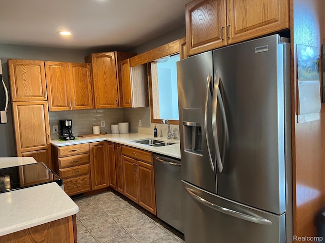 7369 Sheridan Rd, Flushing, MI 48433 - kitchen with appliances with stainless steel finishes, brown cabinetry, light countertops, and recessed lighting