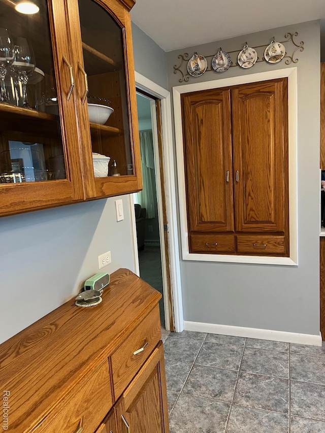 7369 Sheridan Rd, Flushing, MI 48433 - hallway featuring baseboards and dark tile patterned floors