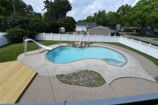 26004 Shirley Ln, Dearborn Heights, MI 48127 - view of pool featuring a water slide, a fenced backyard, a patio, and a pool with connected hot tub