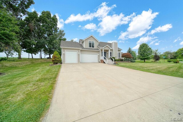 7555 Sherlock Dr, Onsted, MI 49265 - traditional-style home with concrete driveway, a garage, and a front lawn