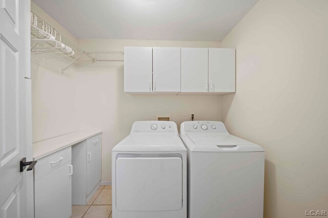 7555 Sherlock Dr, Onsted, MI 49265 - laundry room featuring cabinet space, washer and dryer, and light tile patterned flooring