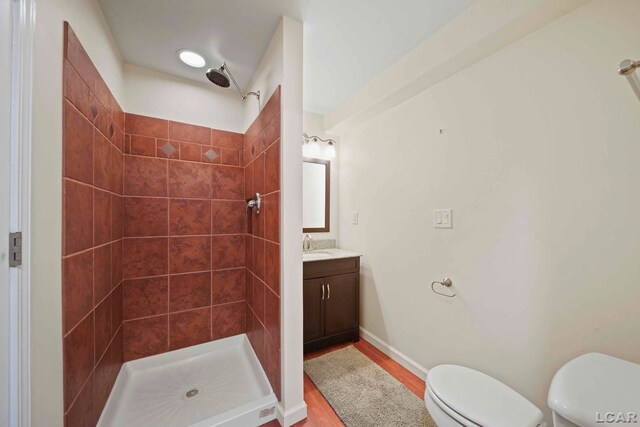 7555 Sherlock Dr, Onsted, MI 49265 - bathroom with a tile shower, vanity, and wood finished floors