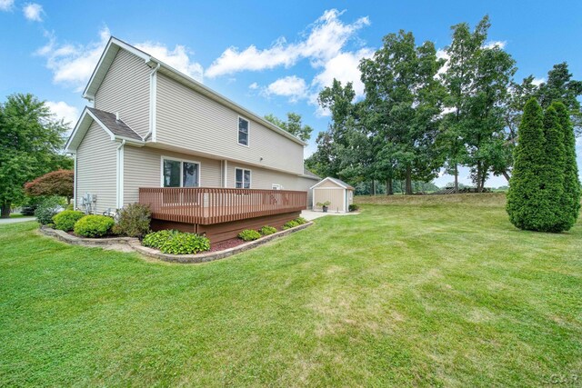 7555 Sherlock Dr, Onsted, MI 49265 - back of house with a wooden deck, a storage shed, and a yard