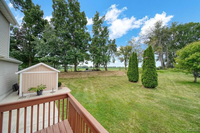 7555 Sherlock Dr, Onsted, MI 49265 - view of grassy yard with a wooden deck and an outdoor structure