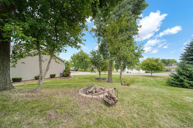 7555 Sherlock Dr, Onsted, MI 49265 - view of grassy yard featuring a fire pit