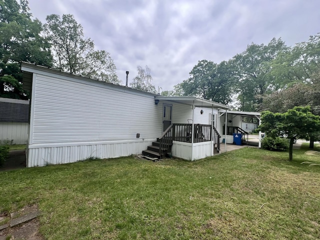 2701 Huizenga St Trlr # 4, Norton Shores, MI 49444 - rear view of house featuring a lawn
