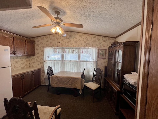 2701 Huizenga St Trlr # 4, Norton Shores, MI 49444 - dining room featuring wallpapered walls, lofted ceiling, crown molding, ceiling fan, and a textured ceiling