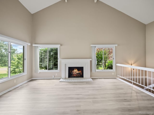 1829 Golf Ridge Dr, Bloomfield Hills, MI 48302 - unfurnished living room with high vaulted ceiling, wood finished floors, and a brick fireplace