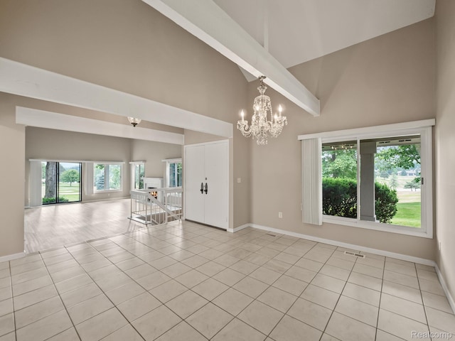 1829 Golf Ridge Dr, Bloomfield Hills, MI 48302 - empty room with high vaulted ceiling, a chandelier, light tile patterned flooring, and plenty of natural light