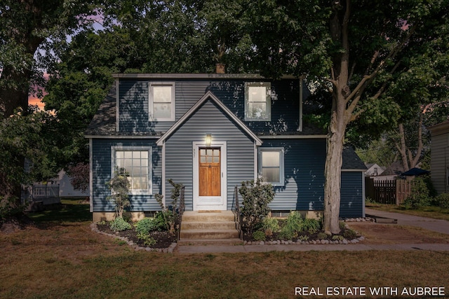 537 Graafschap Rd, Holland, MI 49423 - view of front of home with a front lawn, a chimney, and a shingled roof