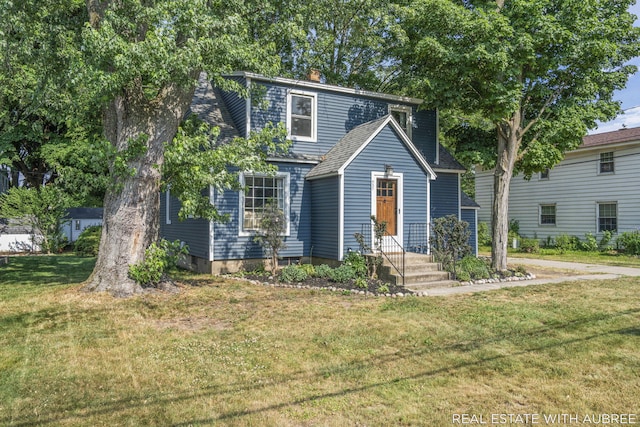 537 Graafschap Rd, Holland, MI 49423 - view of front facade with a front lawn, a shingled roof, and a chimney