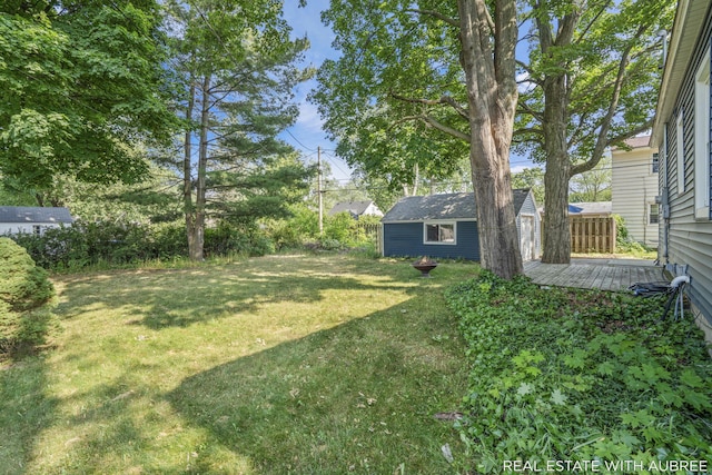 537 Graafschap Rd, Holland, MI 49423 - view of grassy yard featuring an outbuilding and a wooden deck