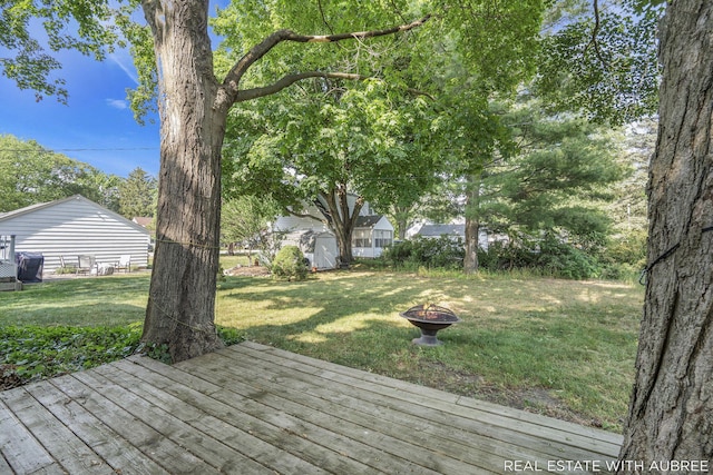537 Graafschap Rd, Holland, MI 49423 - wooden terrace with a storage shed, a fire pit, and a lawn