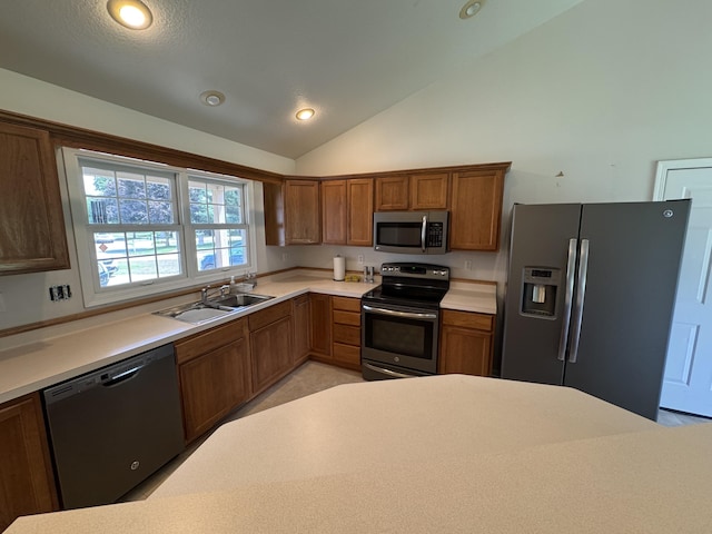 233 Hatch Ave, Coldwater, MI 49036 - kitchen featuring appliances with stainless steel finishes, brown cabinets, light countertops, lofted ceiling, and recessed lighting