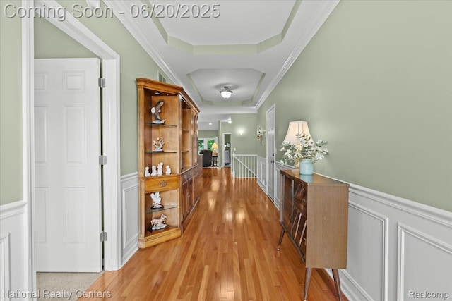 332 Asbury Ct, Highland, MI 48357 - hall with an upstairs landing, a decorative wall, a wainscoted wall, light wood-style floors, and crown molding