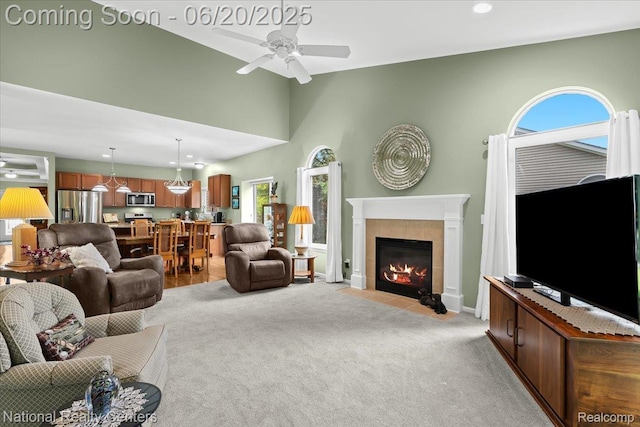 332 Asbury Ct, Highland, MI 48357 - living room featuring a ceiling fan, light colored carpet, a fireplace, recessed lighting, and a high ceiling