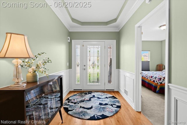 332 Asbury Ct, Highland, MI 48357 - foyer entrance featuring wainscoting, wood finished floors, a tray ceiling, and crown molding